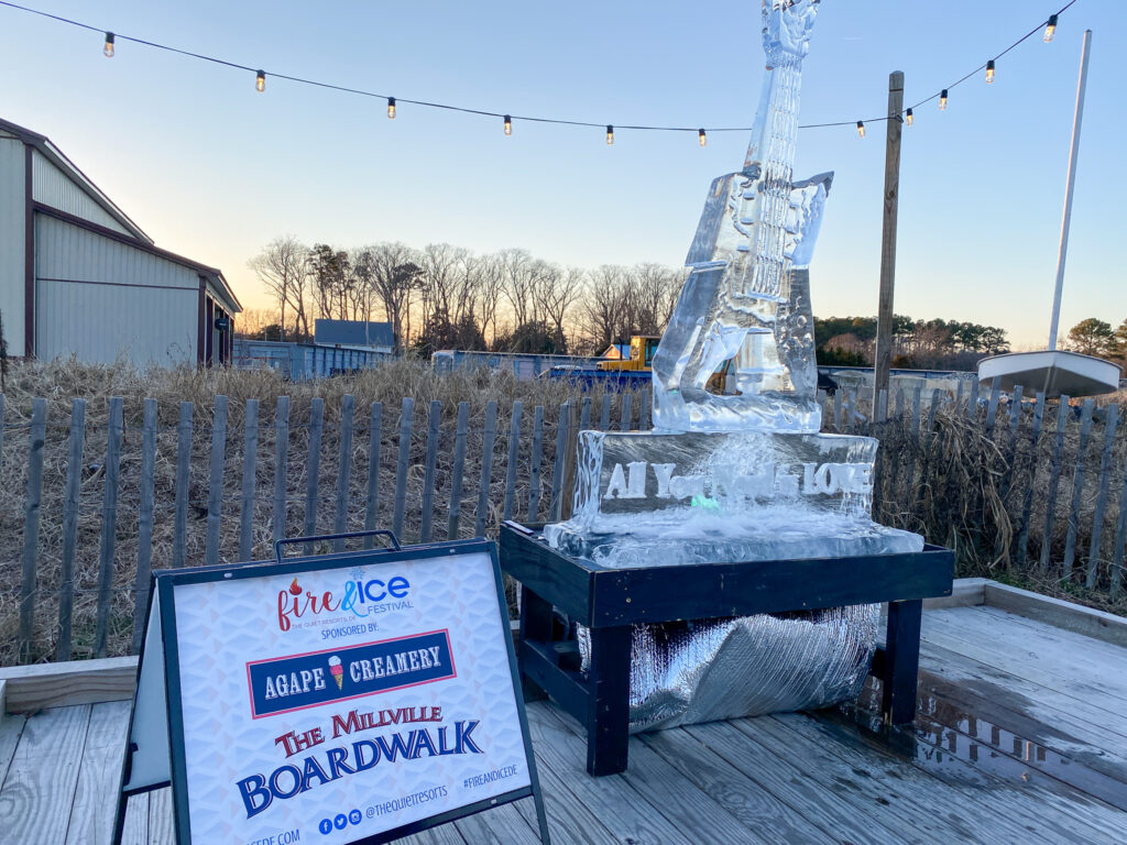 an ice sculpture of a giraffe on a wooden deck