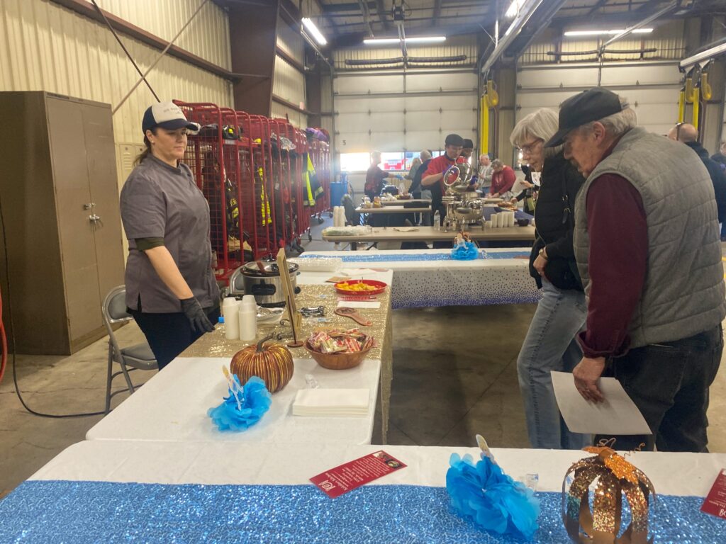 a group of people standing around a table
