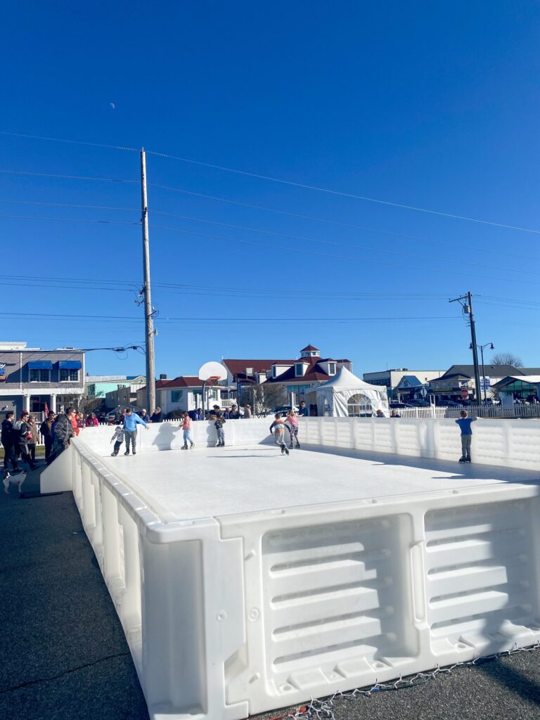 a group of people skating on an ice rink