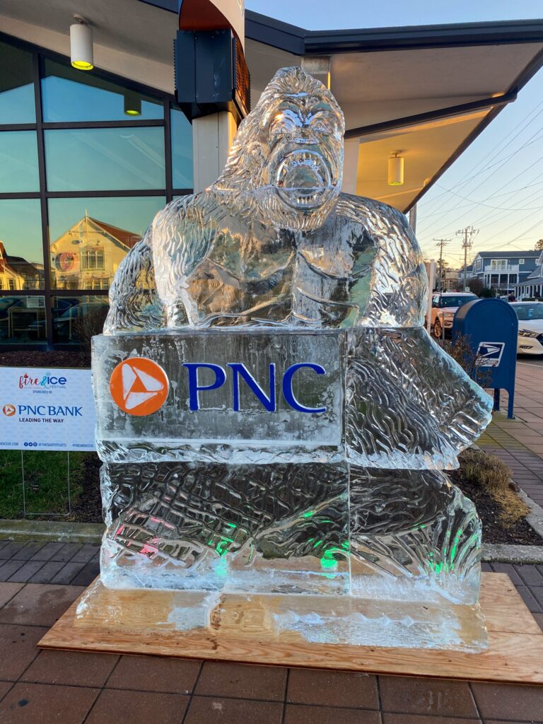 a large ice sculpture of a gorilla sitting on top of a block of ice
