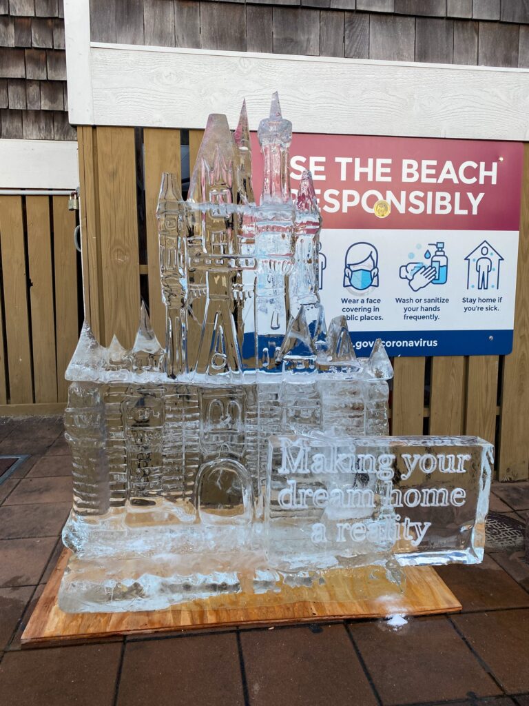 an ice sculpture of a castle with a sign in the background