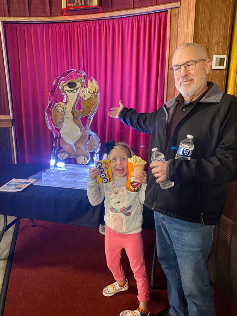 a man and a little girl standing next to each other