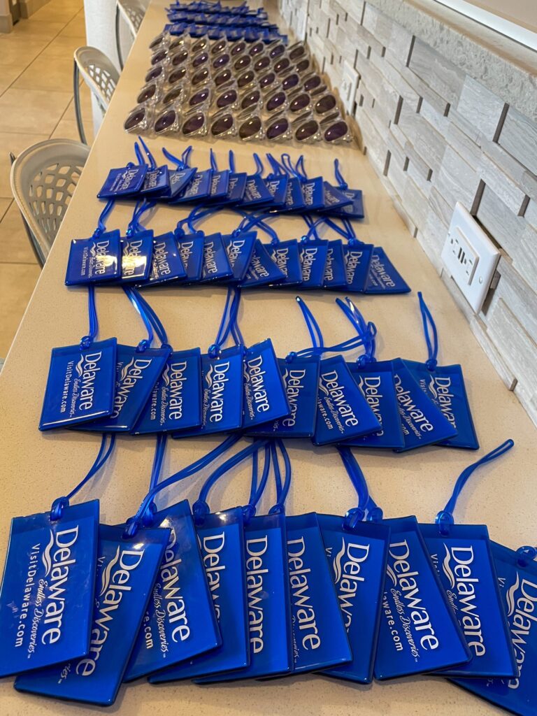 a long table with blue bags of donuts on it