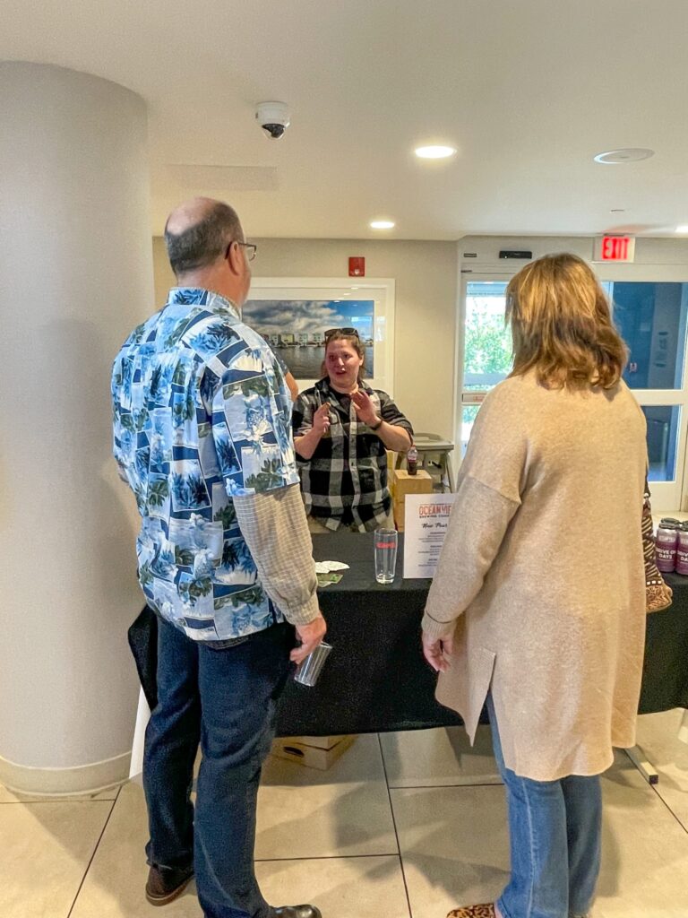 a group of people standing around a table