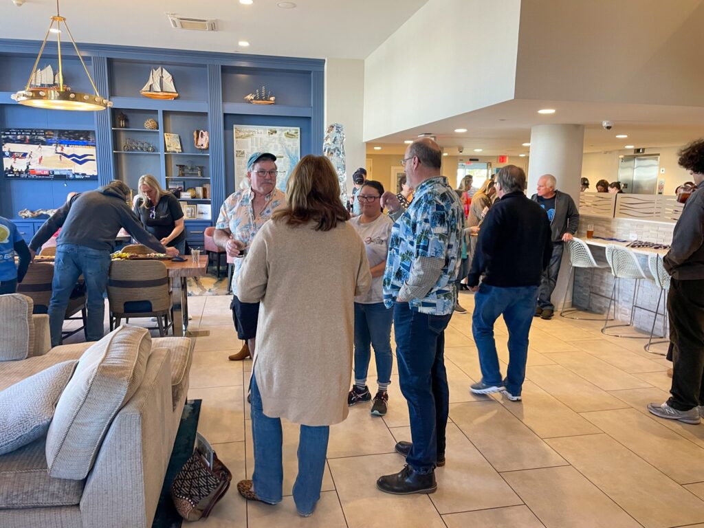 a group of people standing around a living room