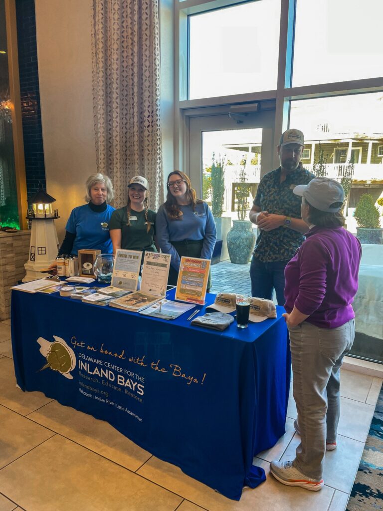 a group of people standing around a table
