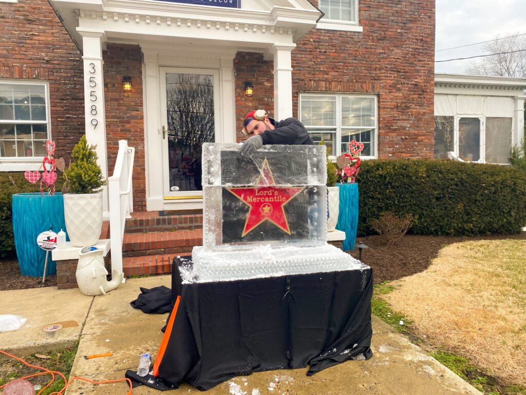 a man standing in front of a building with a star on it