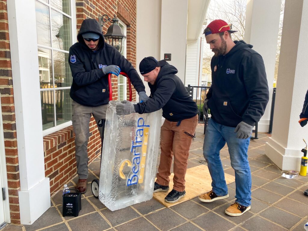 a group of men standing around a bag of ice