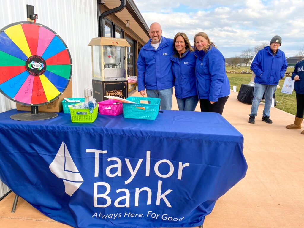 a group of people standing next to a table