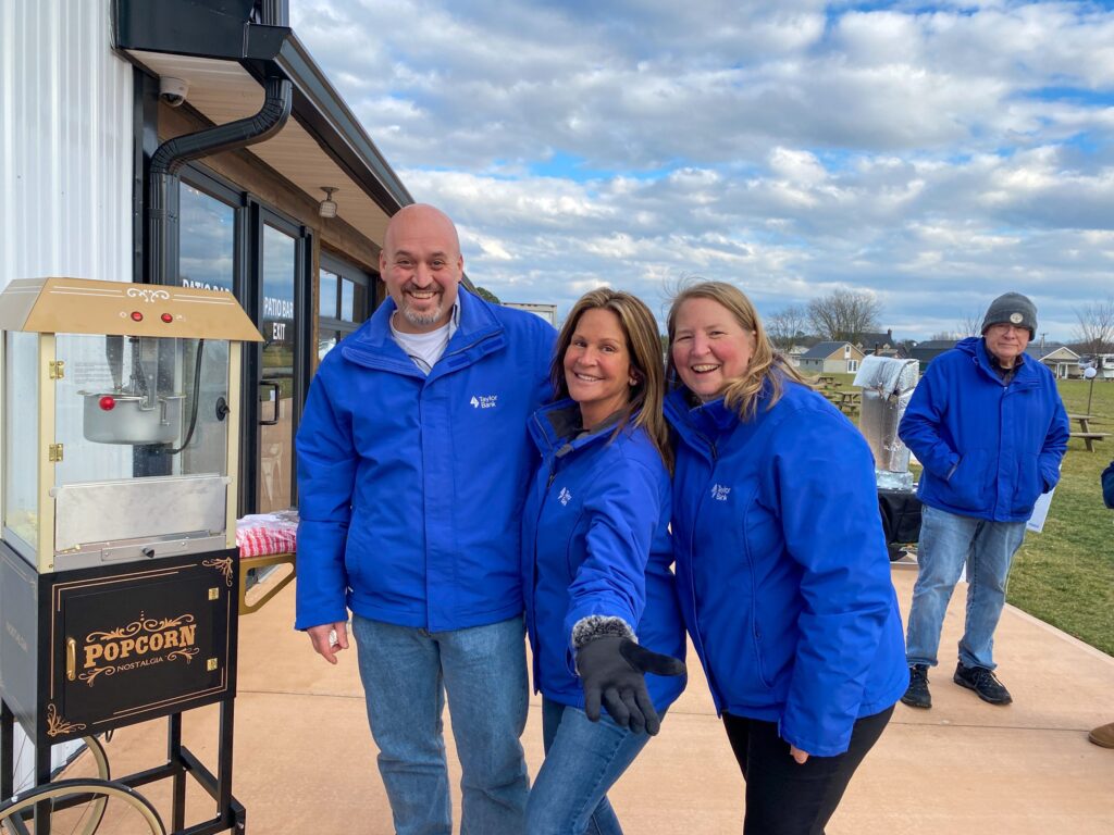 a group of people standing next to each other in front of a building