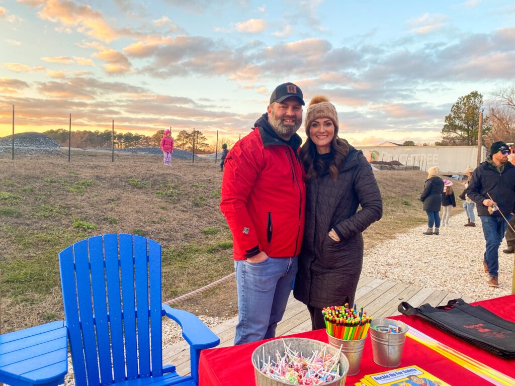 a man and woman standing in front of a table
