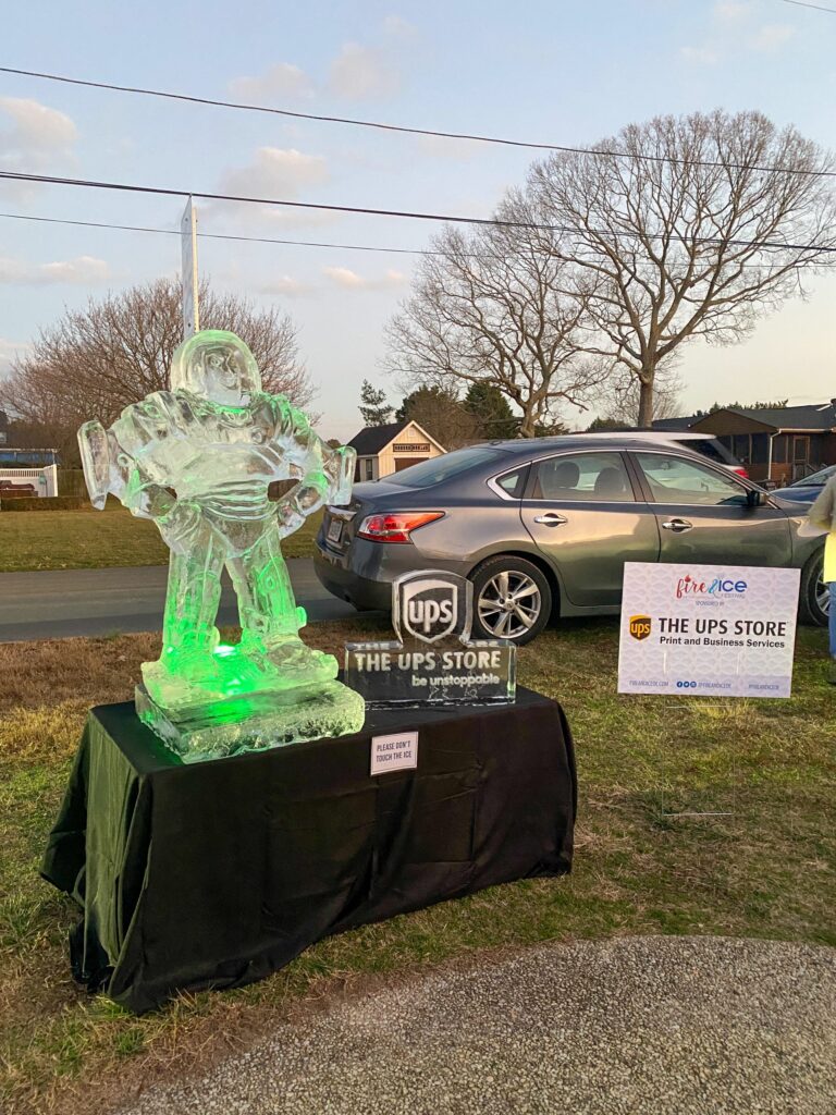 a couple of green glass statues sitting on top of a lush green field