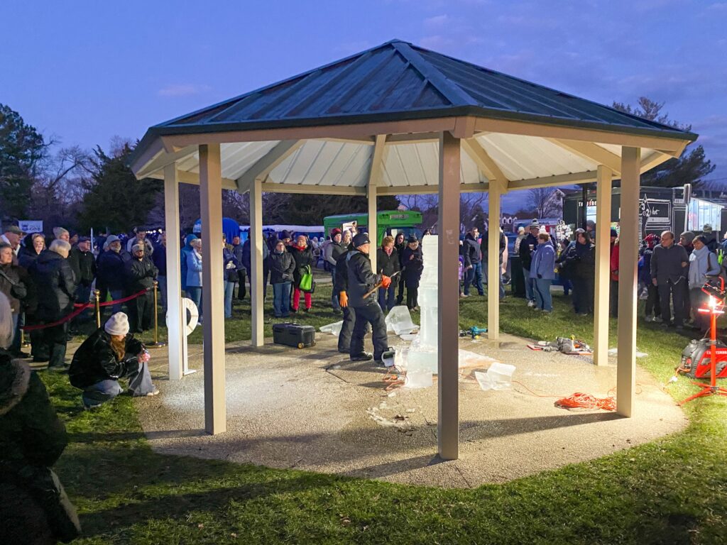 a group of people standing around a gazebo