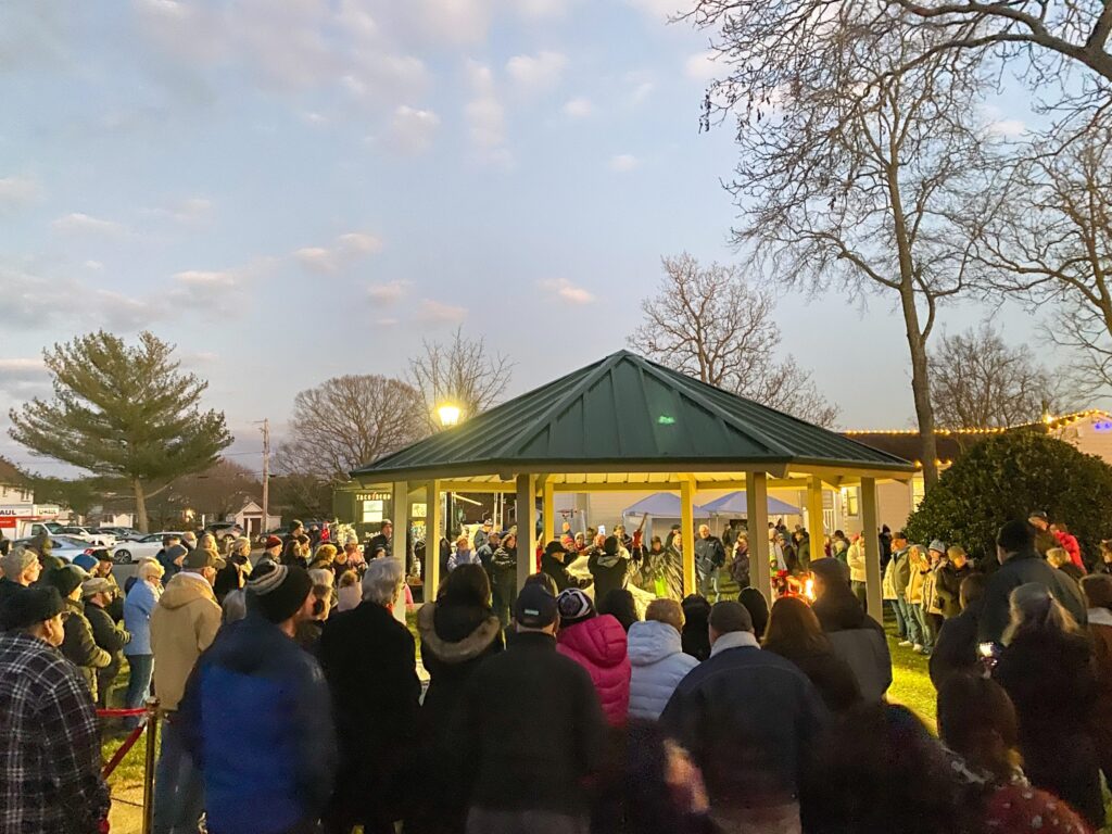 a crowd of people standing around a gazebo