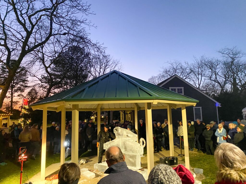 a group of people standing around a gazebo