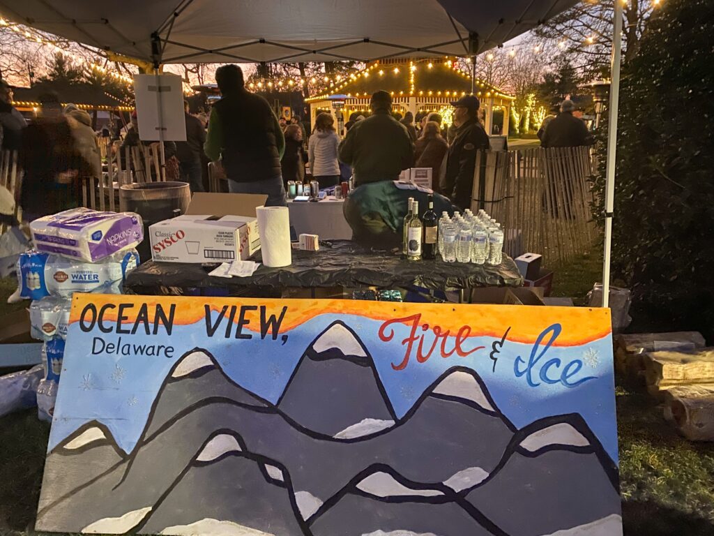 a painting of a mountain is on display under an umbrella