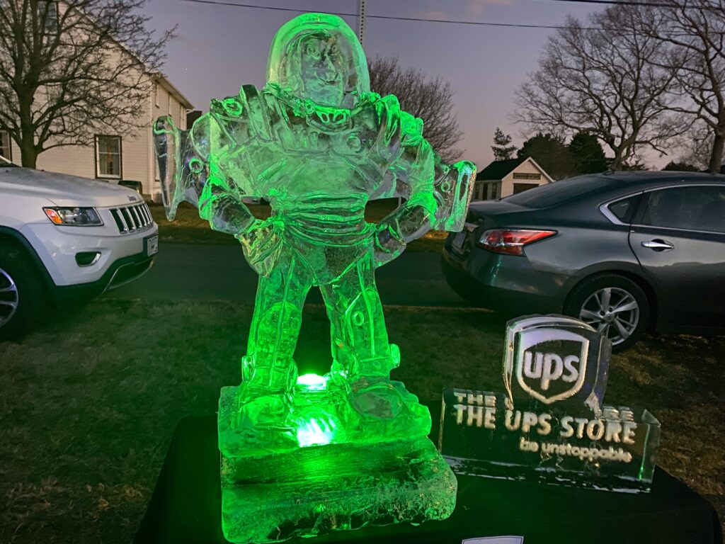 a lighted statue of a man in a green suit