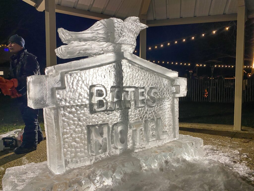 a man standing next to a large ice sculpture