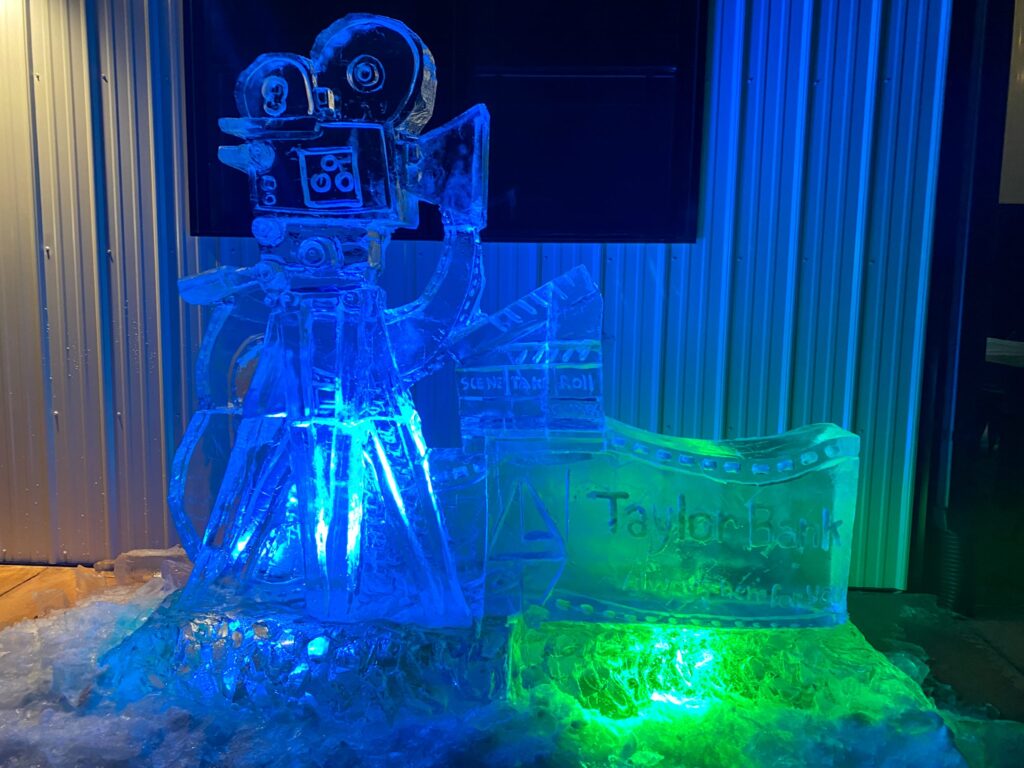 a couple of ice sculptures sitting on top of a pile of snow