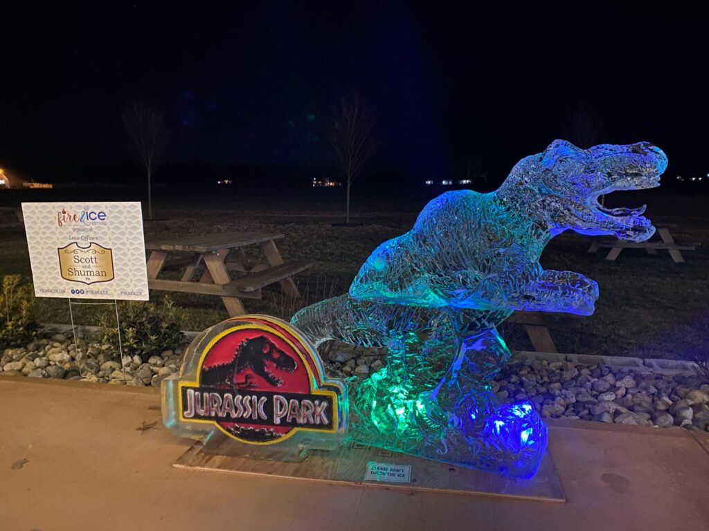 a lit up sign with a lit up dinosaur on it