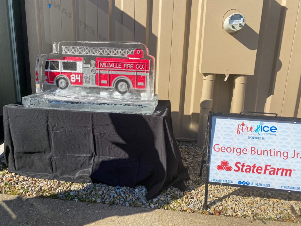 a fake fire truck is on display in front of a state farm sign
