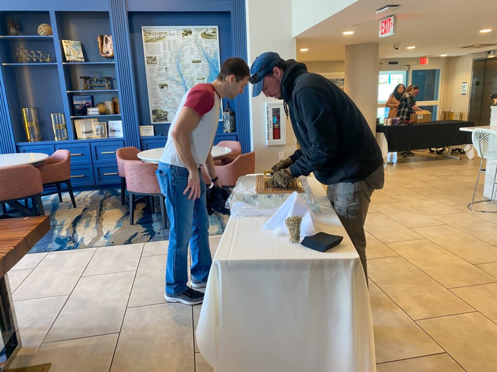 a couple of men standing next to each other in a room