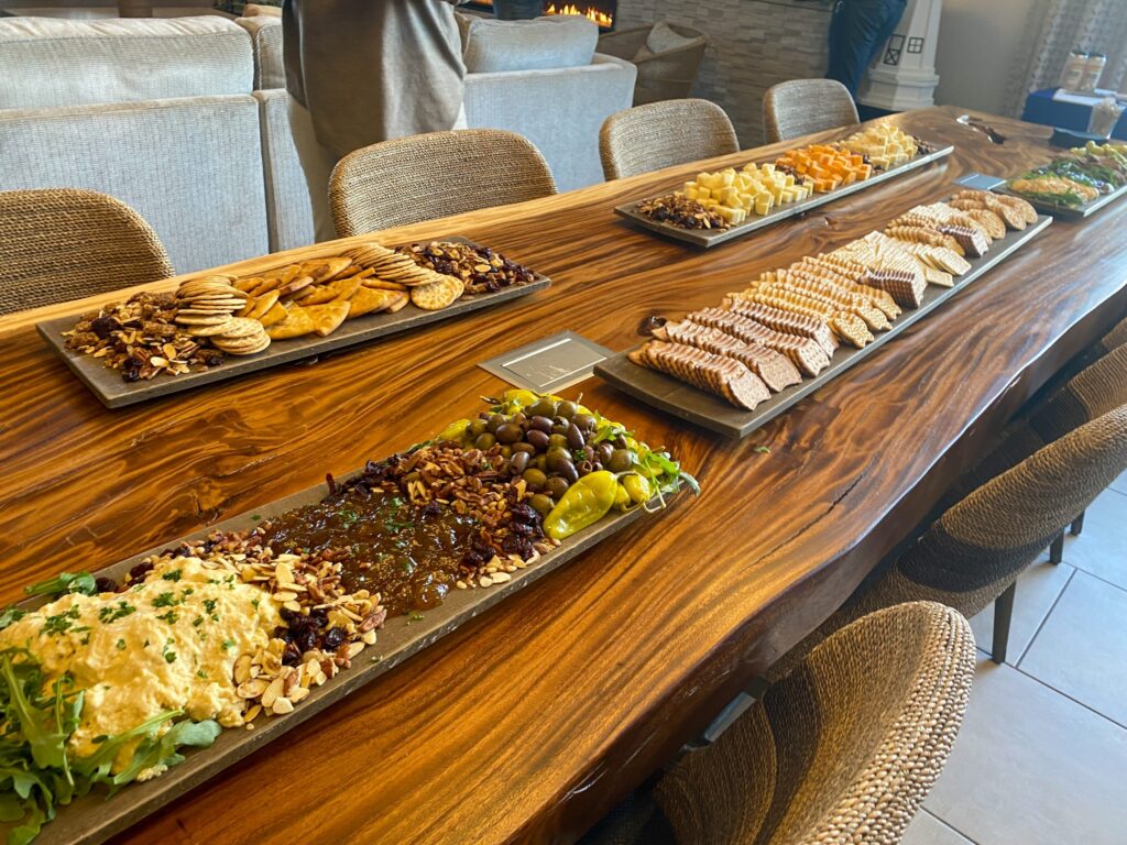 a wooden table topped with plates of food