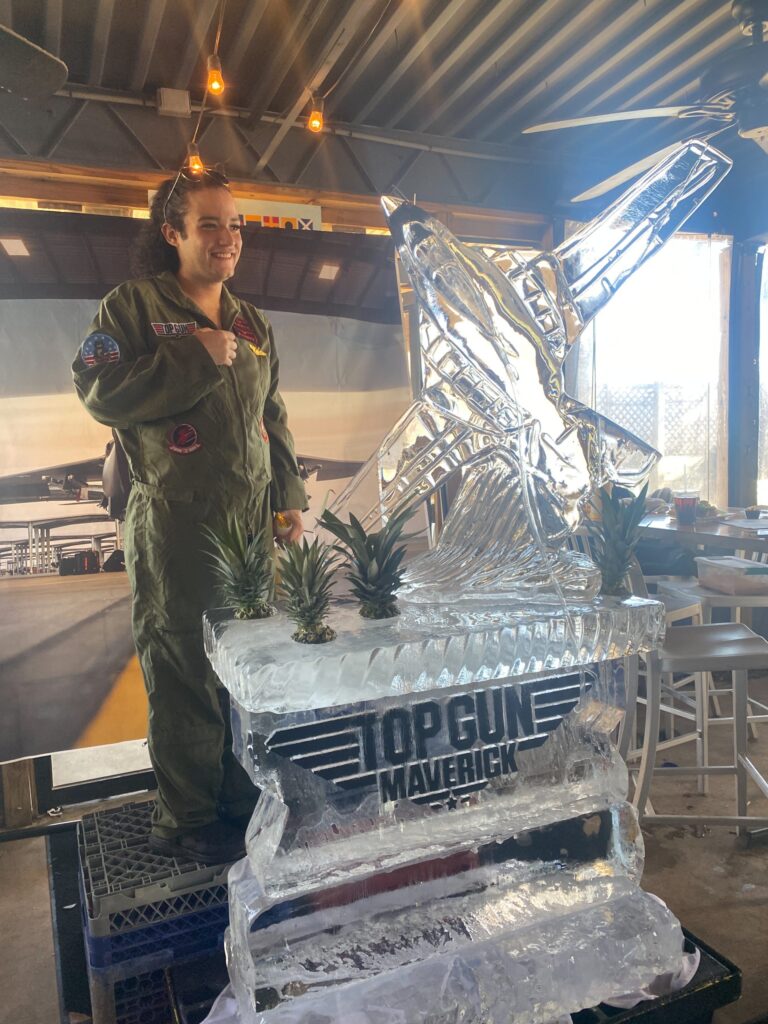 a man standing next to an ice sculpture
