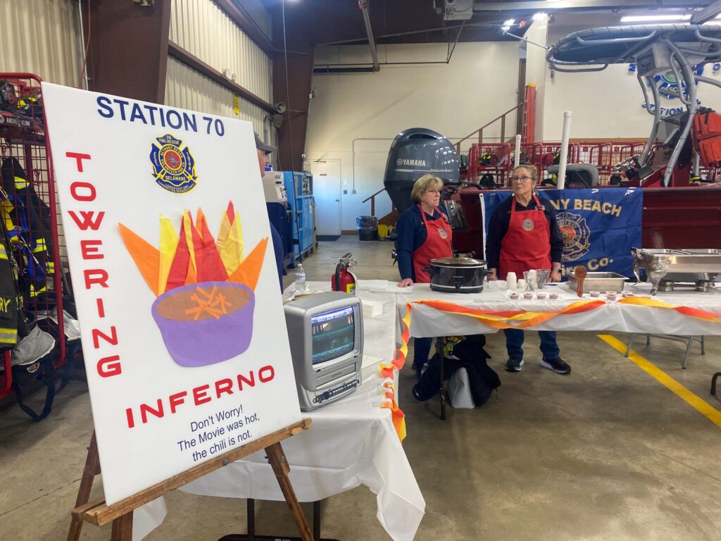 a group of people standing around a table with a sign