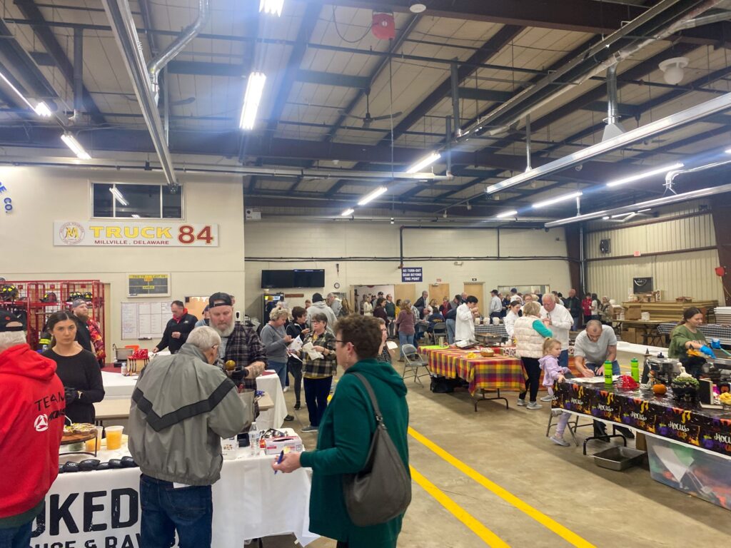a group of people standing around a table