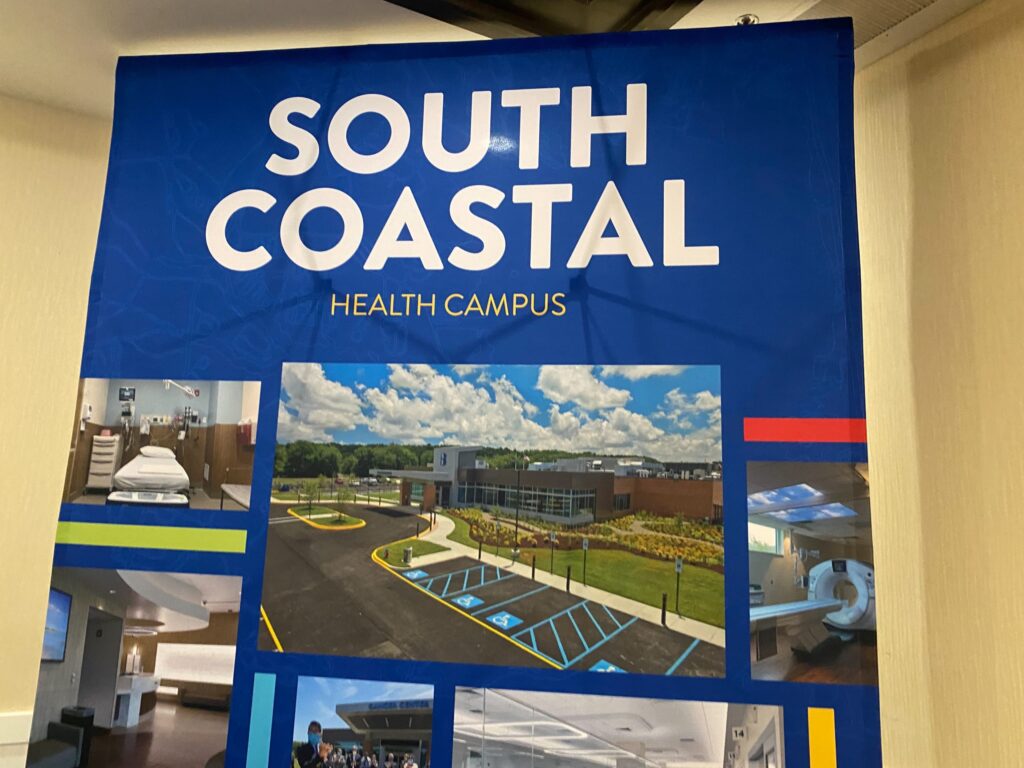 a blue sign hanging from the side of a wall