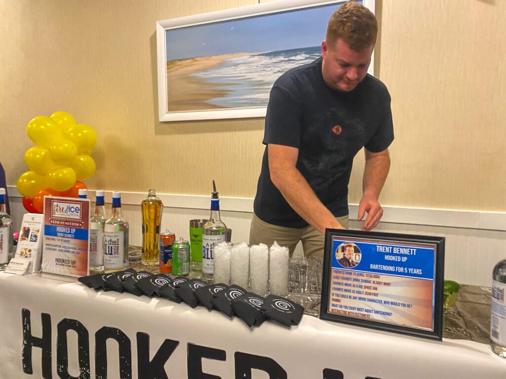 a man standing behind a table with a sign on it