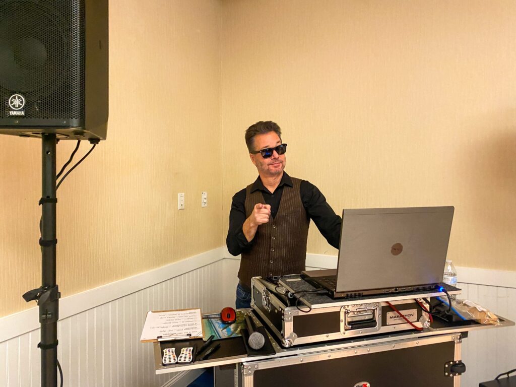 a man standing in front of a laptop computer