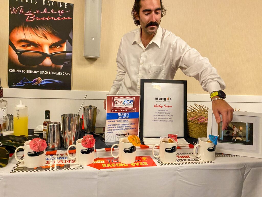 a man standing next to a table with pictures on it