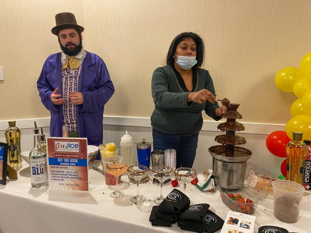 a man and a woman standing behind a table