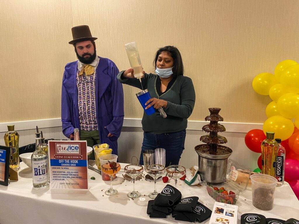 a man and a woman standing behind a table