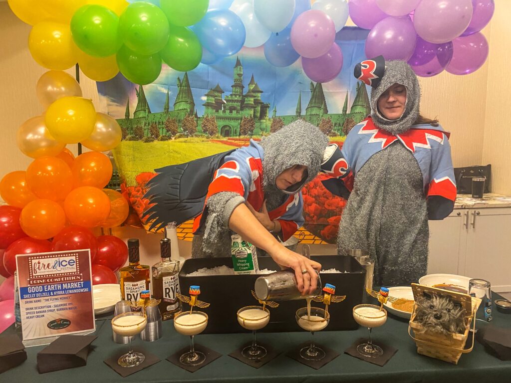 a couple of people that are standing in front of a table