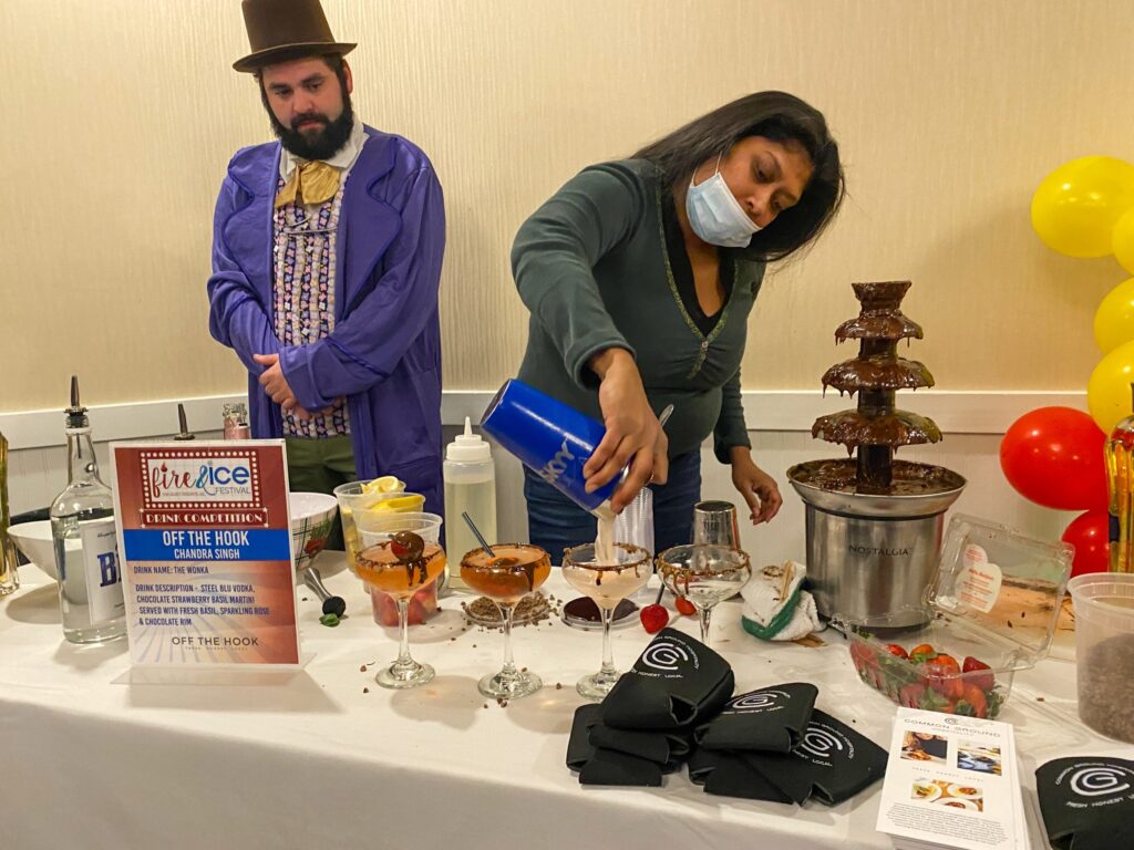 a man and a woman standing behind a table