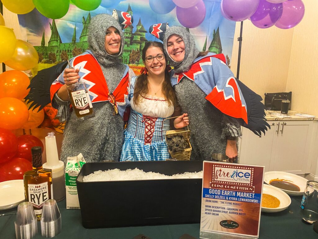 a couple of people that are standing in front of a table