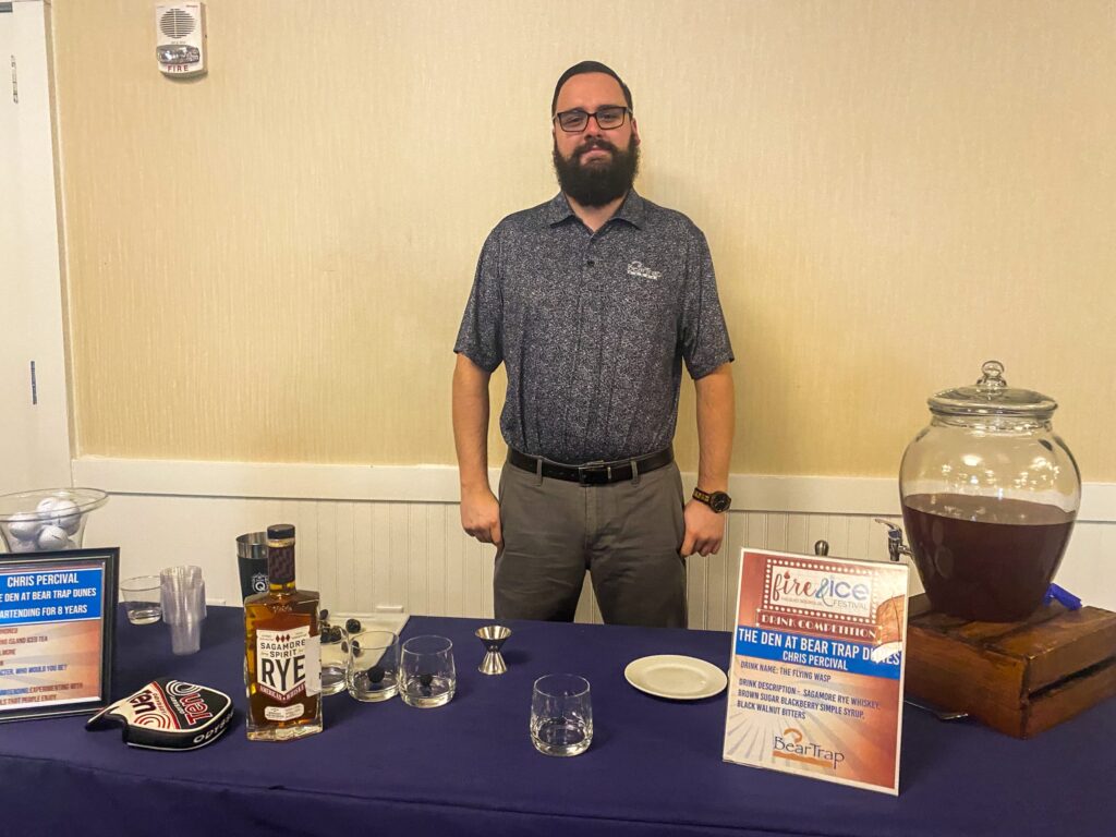 a man standing in front of a blue table