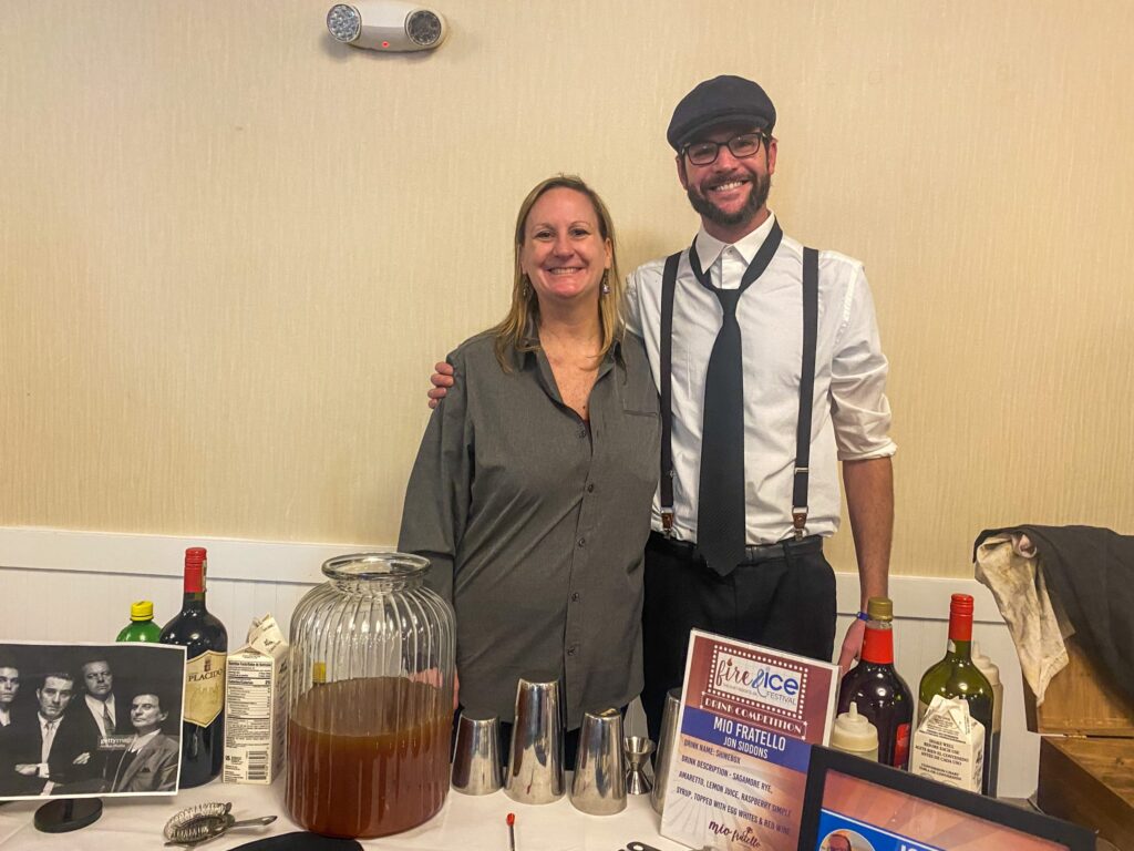 a man and a woman standing next to a table