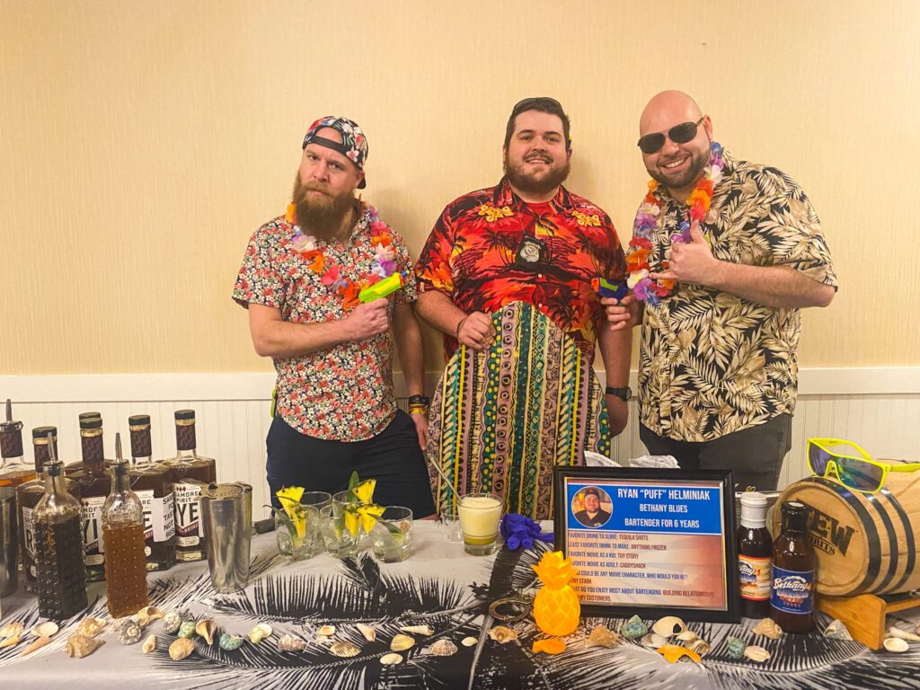 a group of men standing next to each other in front of a table
