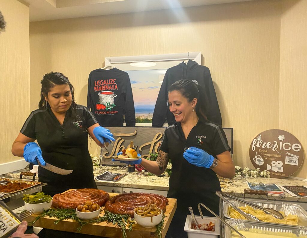 a couple of people that are standing in front of some food