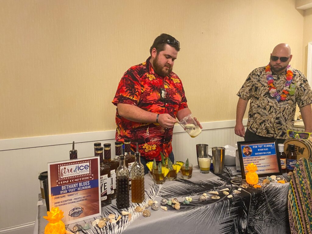 a couple of men standing next to a table