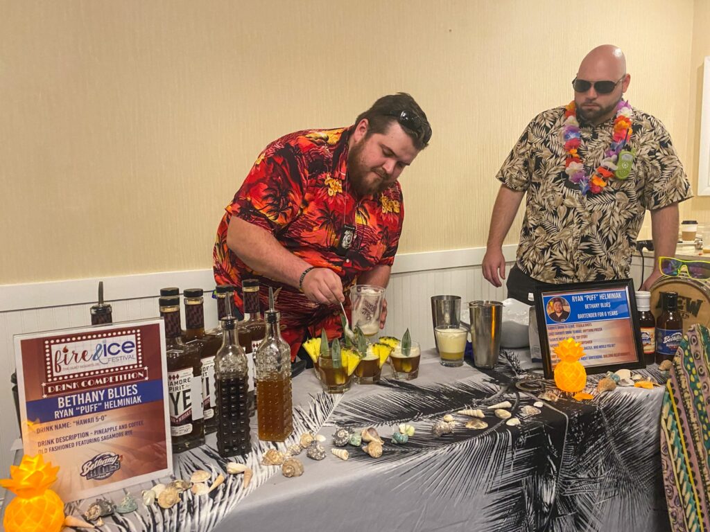 a couple of men standing next to a table