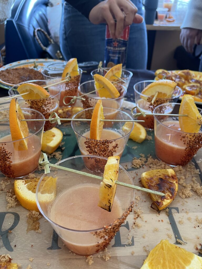 a table topped with cups filled with different types of food