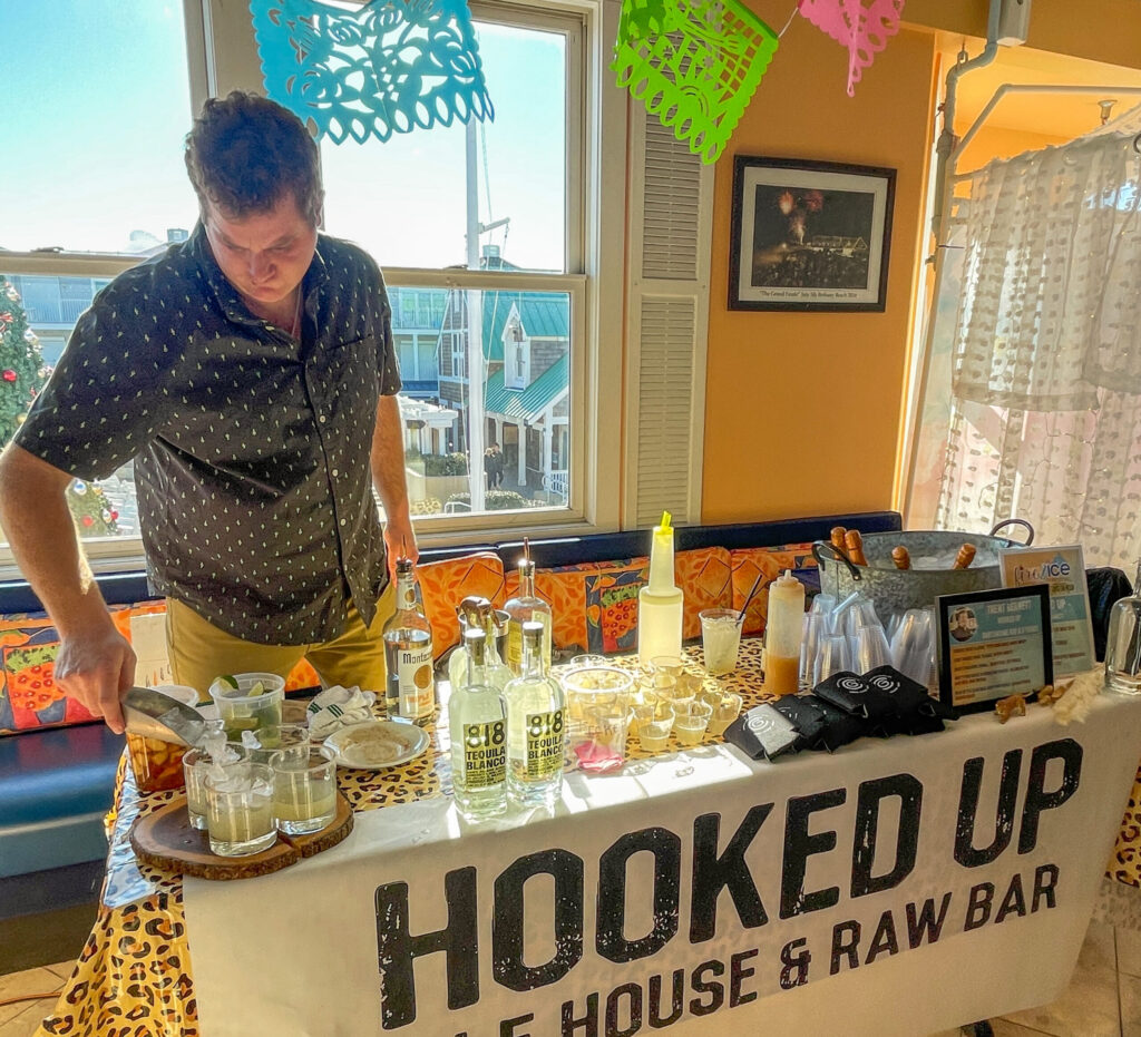 a man standing at a table with a sign on it