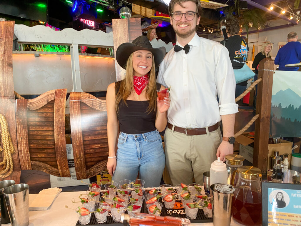 a man and a woman standing in front of a table