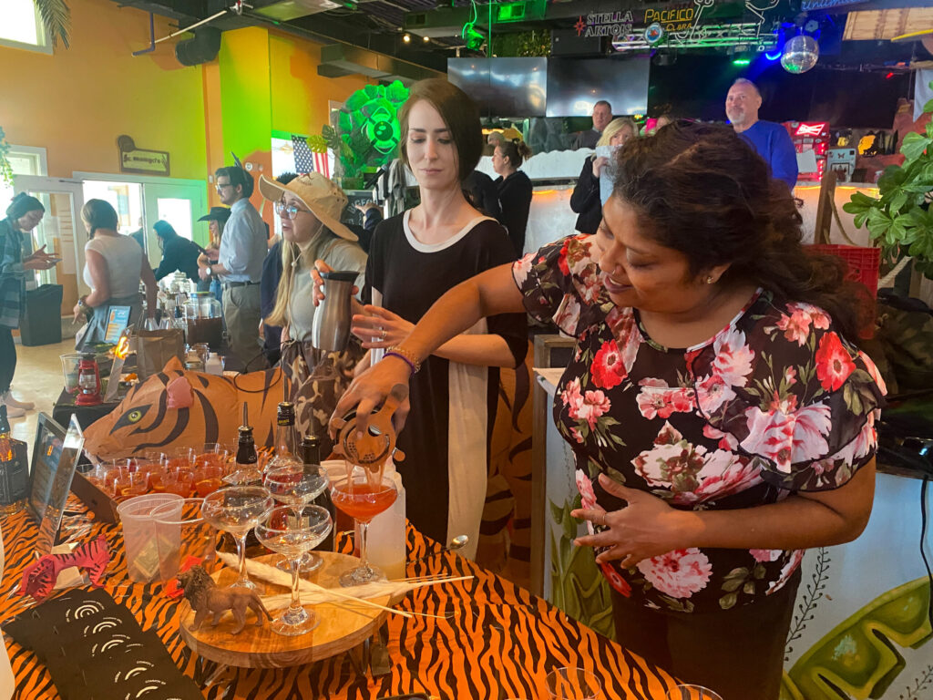 a group of people standing around a table
