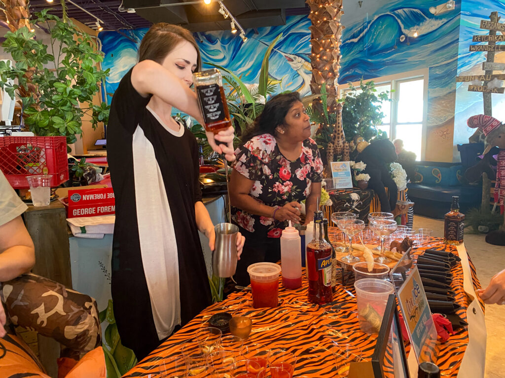 a group of people standing around a table